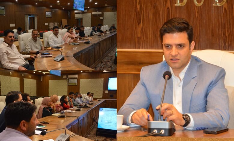 Deputy Commissioner Athar Aamir Khan reviewing Census 2027 preparations in Budgam district with officials during a meeting.