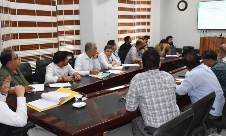 Agriculture Scheme Review meeting showing DC Minga Sherpa reviewing progress of HADP, PM-Kisan and KCC schemes with officials in discussion meeting room