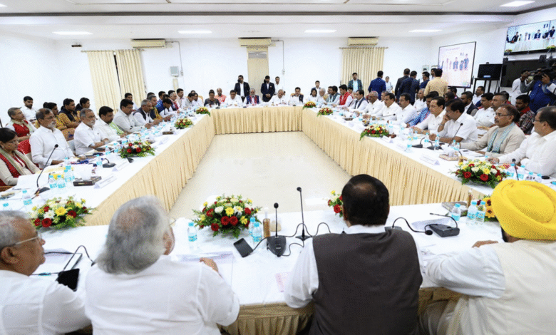 Formal political meeting with leaders seated around a large U-shaped table in a conference hall during INDIA Bloc discussions in Delhi.