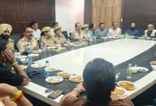 Officials inspecting Jammu Fruit Prices at a wholesale fruit market