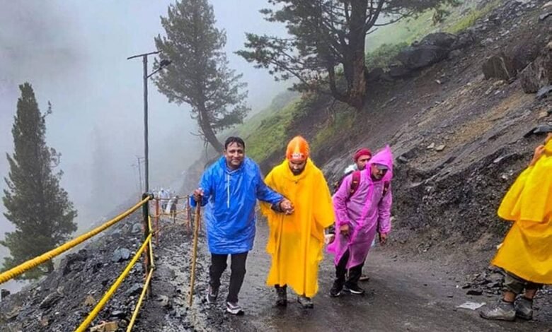 Amarnath Yatra Update showing pilgrims trekking to Holy Cave in rain